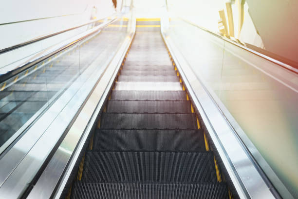 istock Moving stairway on escalator in interior of a public place 1489455103