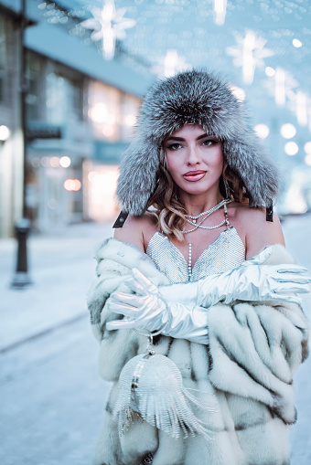 girl wearing warm clothes hat and fur coat