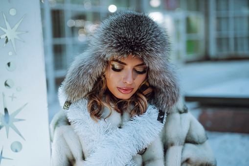 Fashionable young woman outdoors in winter