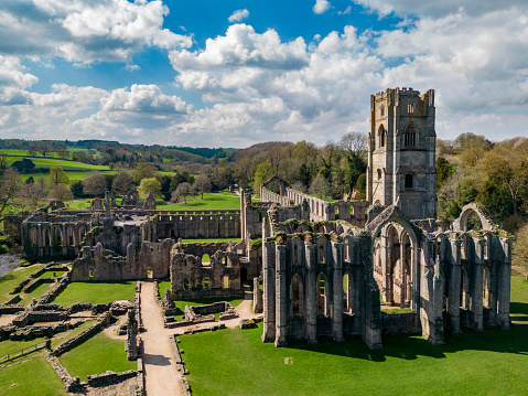 Aerial view of the ruins of Fountains Abbey near Ripon in North Yorkshire in the northeast of England. Founded in 1132, the abbey operated for 407 years, becoming one of the wealthiest monasteries in England until its dissolution, by order of King Henry VIII, in 1539.