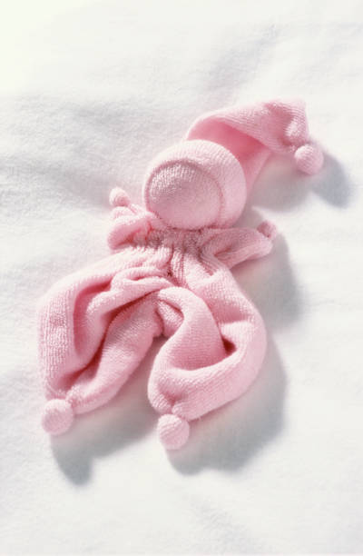 istock Soft pink baby doll for newborn babies on white background 1489462961