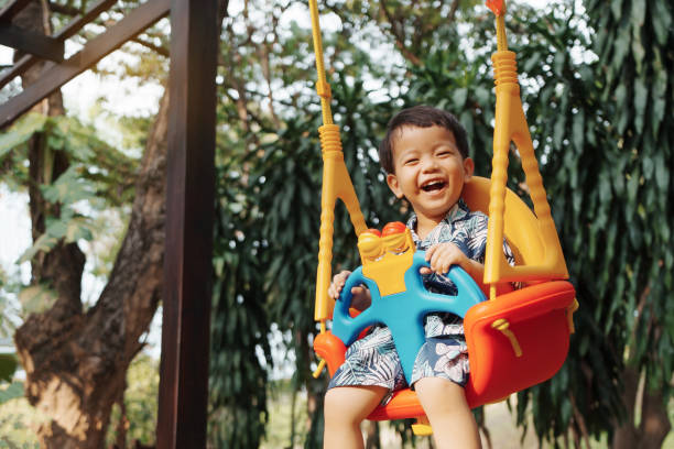 istock Cute little Asian child boy having fun on swing 1489465685