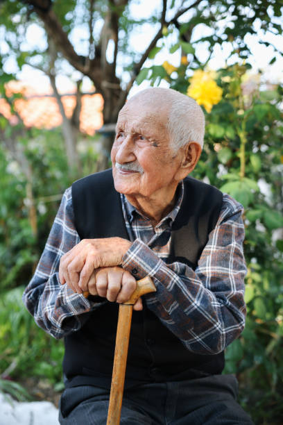 istock Elderly man sitting on a chair 1489465808