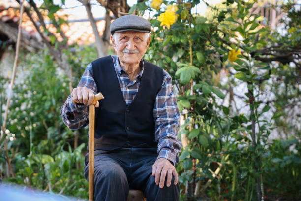 istock Elderly man sitting on a chair 1489466672