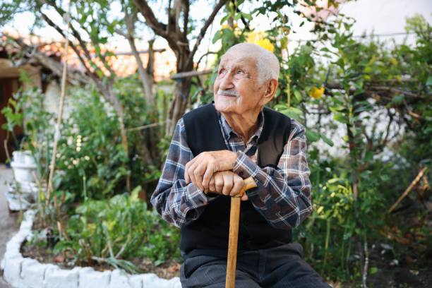 istock Elderly man sitting on a chair 1489467174