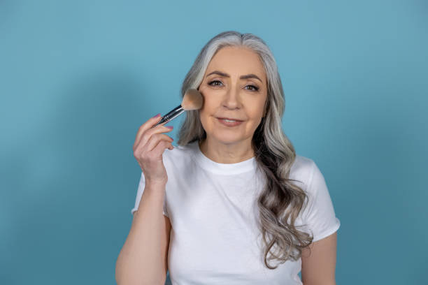 istock Beautiful senior woman with face brushes 1489469698