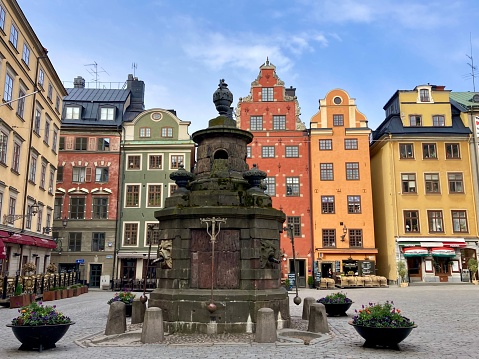 Street with old colorful buildings in Old Town district in Stockholm, Sweden. Famous tourist location