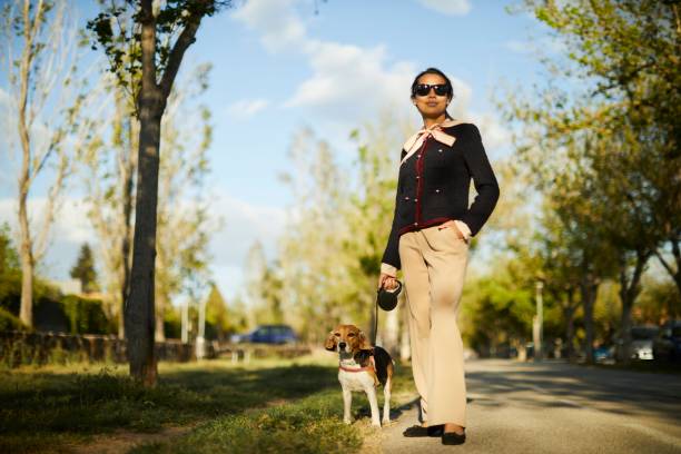 Young woman walking her dog in the city.