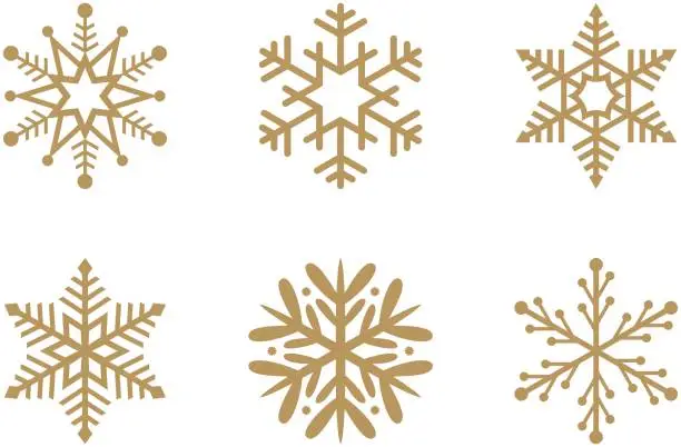 Vector illustration of Gold frosty abstract snowflake symbols set on white background.