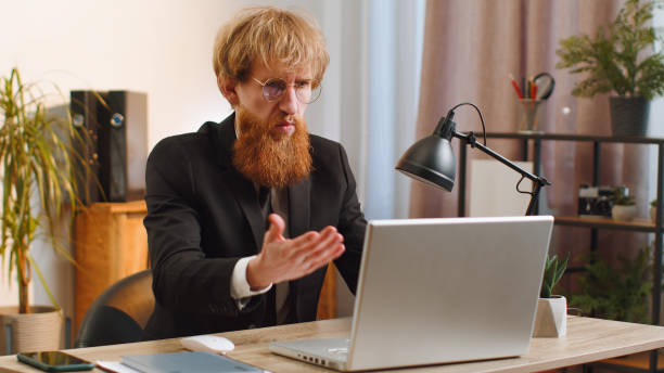 istock Irritated shocked businessman working on laptop website problem, computer virus data loss by hacking 1489473750