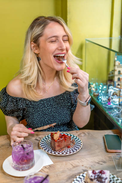 istock Woman eats chocolate and strawberry cake in cafe 1489474226