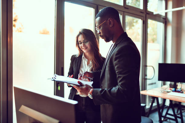 istock Multiethnic Businessman And Secretary Checking Documents Ready To Be Signed 1489474782
