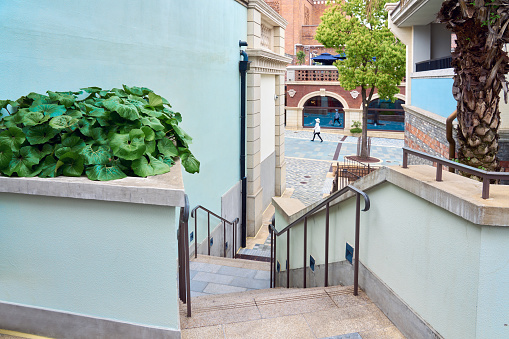 Tourists walk in the empty alleys of the Western-style town