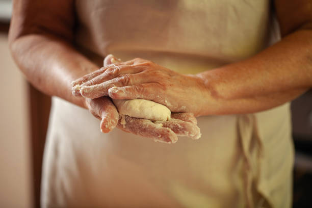 istock Women's hands make pasty dough 1489477996