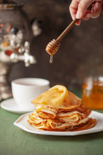 istock Pancakes or crepes in a plate with honey and tea 1489478116