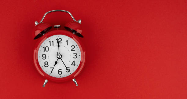 istock Red alarm clock on a red background. Top view. 1489480471