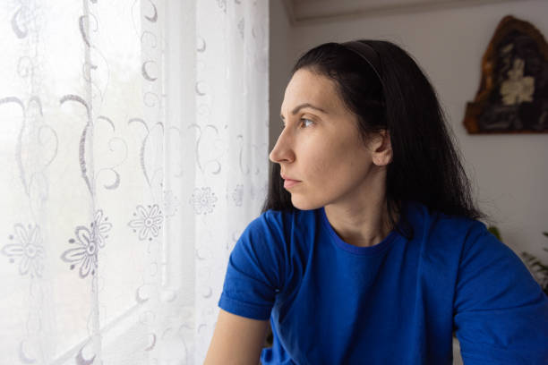 istock Woman sitting on the window 1489481334