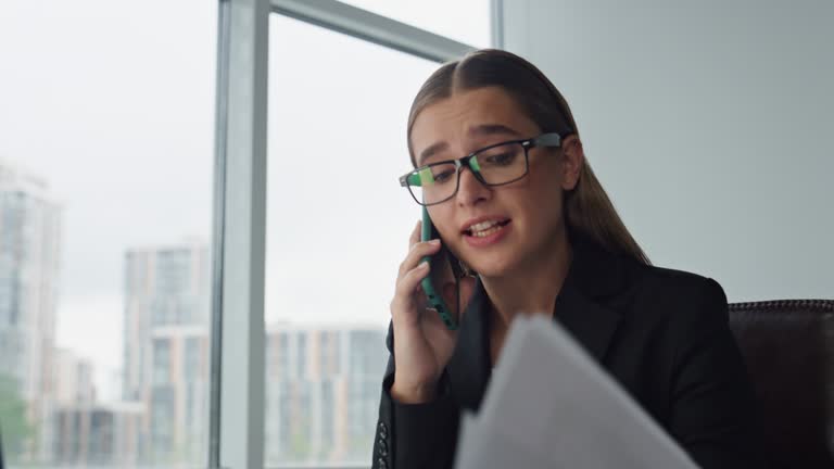 Desperate businesswoman talk phone in office closeup. Worried manager complain