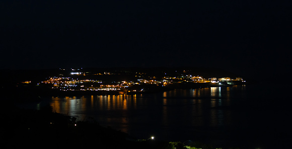 In the distance, the city of Santa Cesarea Terme and the calm waters of the Ionian Sea in the dead of night.