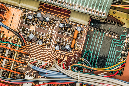 Photograph of vintage electronic board multicolored detail, viewed directly above.