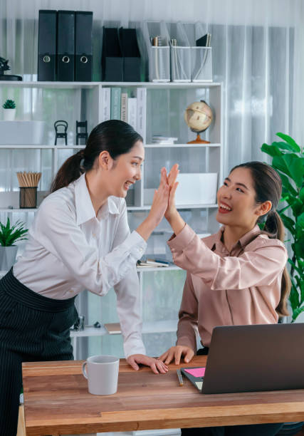 istock Colleagues in the office workspace give high-five. Enthusiastic 1489493320