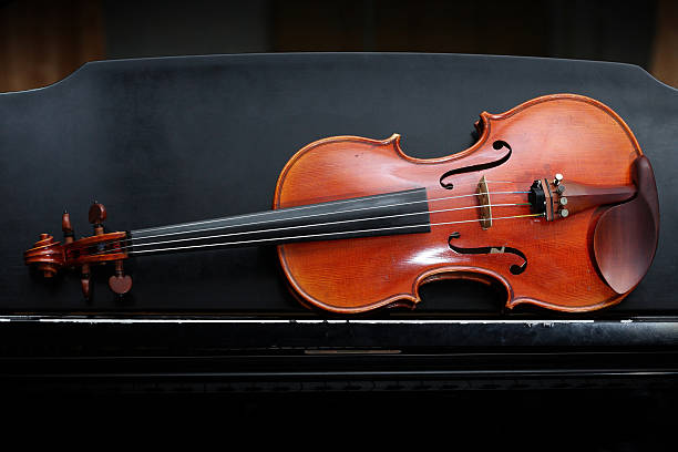 istock violin on black piano. 148949386