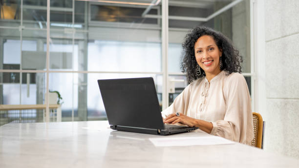 istock Businesswoman using laptop in office portrait 1489494493