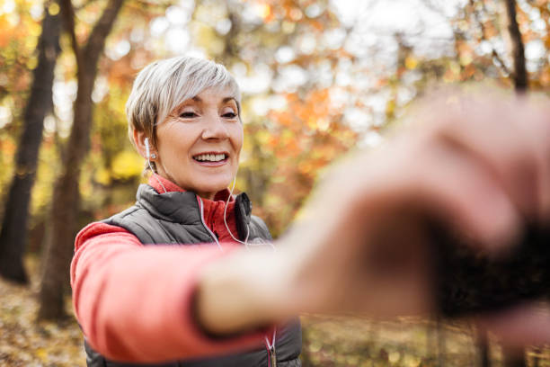 istock Mature woman posing at smartphone camera making selfie 1489494570
