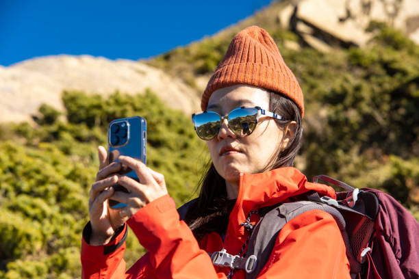 istock Mountain hiker using Ssmart phone on the mountain top. 1489494798