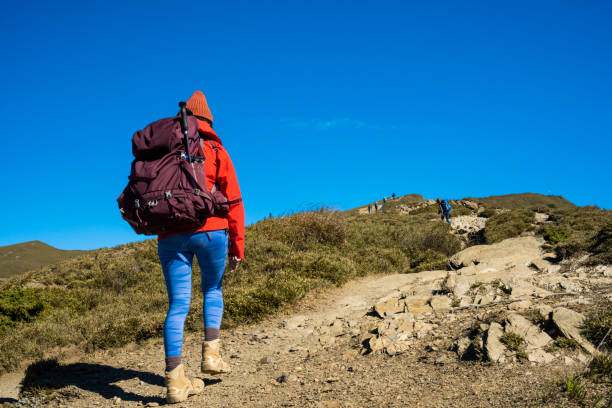 istock Hikers walking alone on top of a mountain. 1489494800