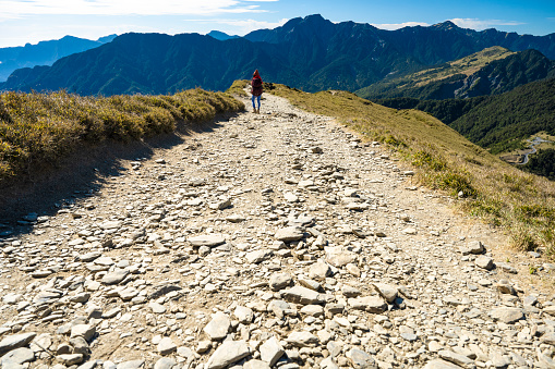 Hikers walking alone on top of a mountain.