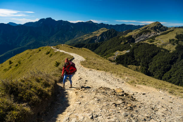 istock Hikers walking alone on top of a mountain. 1489495424