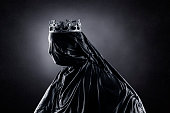 Ghost of a queen or king over dark misty background