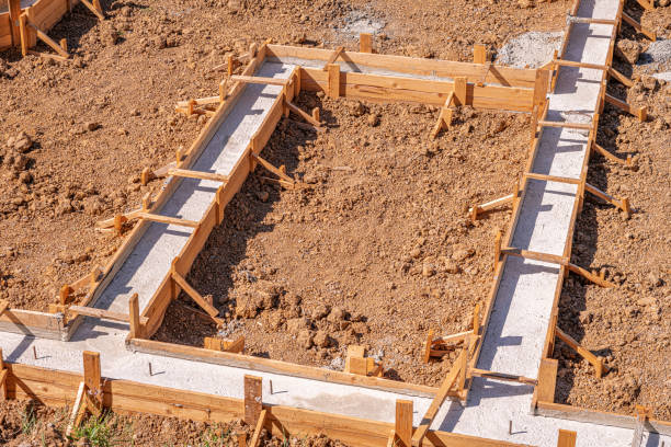 Wooden formwork for pouring concrete foundation of the house. Wooden formwork for pouring concrete foundation of the house. Foundation construction. concrete in formwork stock pictures, royalty-free photos & images