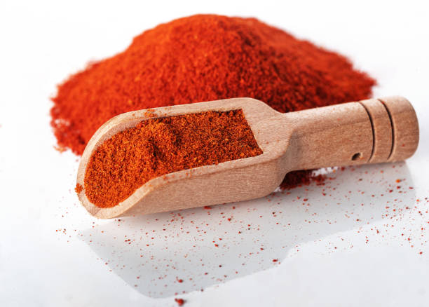 istock Wooden spoon on a paprika slide, isolated on a white background. General view 1489498625