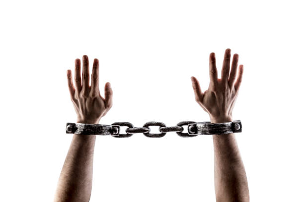 istock Shackled hands isolated on white background with clipping path 1489498723