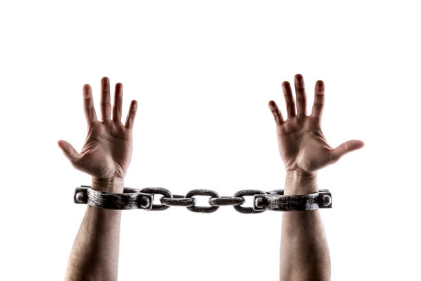 istock Shackled hands isolated on white background with clipping path 1489498732