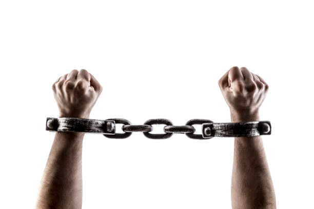 istock Shackled hands isolated on white background with clipping path 1489498771