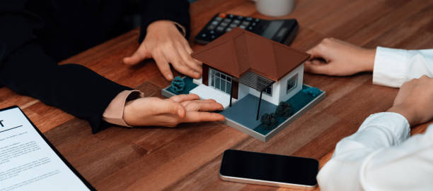 istock Reviewing house loan contract with agent using calculator. Enthusiastic 1489500043