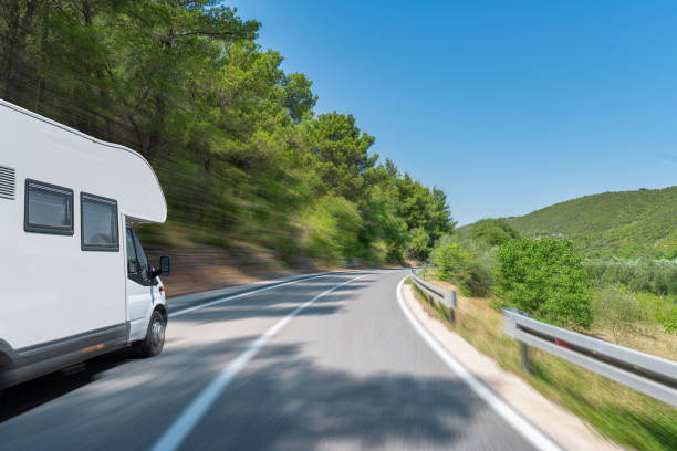istock Camper trailer on Highway. road trip in motorhome 1489501805