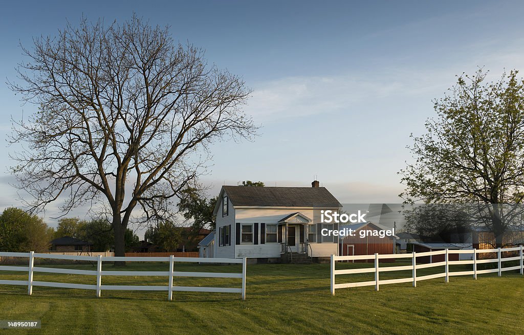 White farmhouse White farmhouse behind white fence in rural Illinois Farmhouse Stock Photo