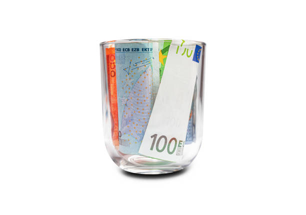 Euro banknotes in a glass isolated on a white background.
