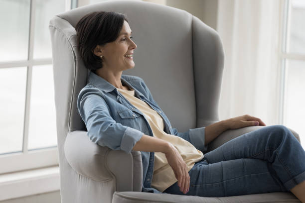 istock Cheerful middle aged brunette lady relaxing at home 1489504304