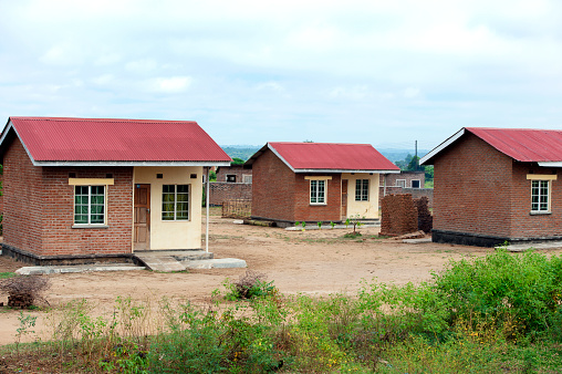 Flood relief replacement housing, near Blantyre, Malawi, Africa. Following devastating floods the government built relief housing for those displaced by the extreme weather of 2023. Malawi, the landlocked country in southeastern Africa, is a country of highlands split by the Great Rift Valley and the huge Lake Malawi, whose southern end is within Lake Malawi National Park and several other parks are now habitat for diverse wildlife from colorful fish to the Big Five. Cape Maclear is known for its beach resorts, whilst several islands offer rest and recreation.
