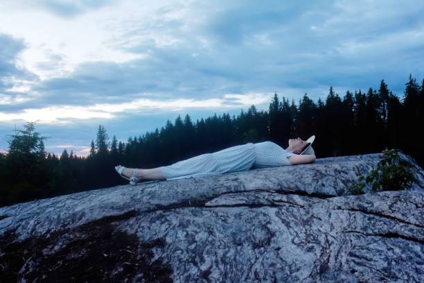 istock Young woman dancing on the rock on the sunset 1489507794