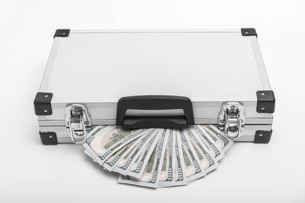istock Suitcase with money on a white background. 1489508296