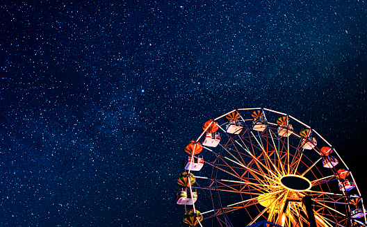 Ferris wheel on a background of the starry night sky in the city of Sunny Beach, Bulgaria.