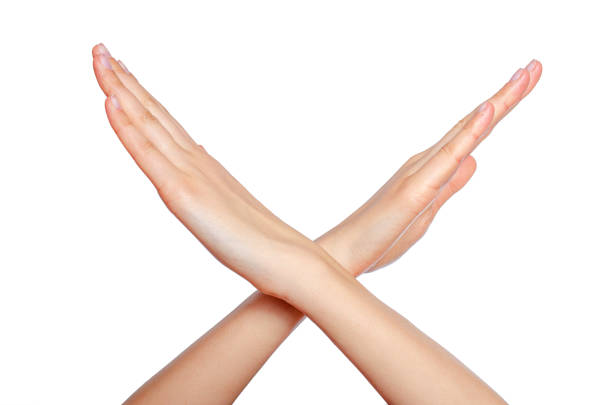 istock Female crossing hands forming an x isolated on white 1489509648