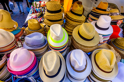 straw hats at a market - photo