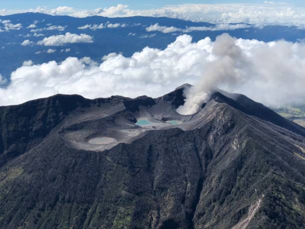 istock View of an active volcano with billowing clouds in the background 1489510772